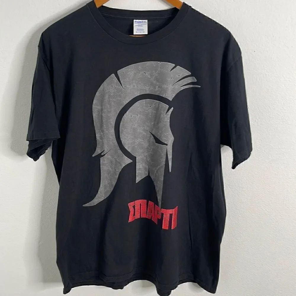 Port & Co. Spartan warrior T-shirt. Size XL. Wording reads warrior in Ukrainian.